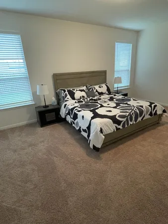 a bed room with a bed and a chair