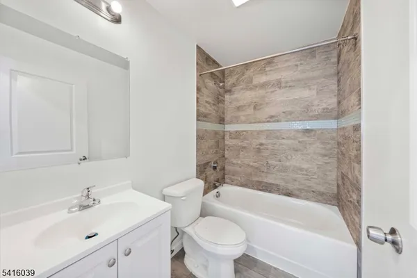a bathroom with a sink mirror bathtub and toilet