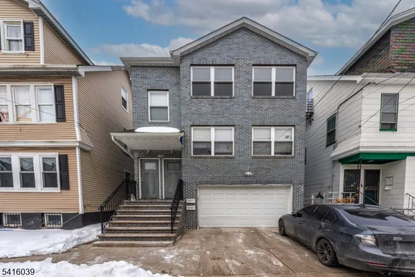 a front view of a house with a yard and balcony