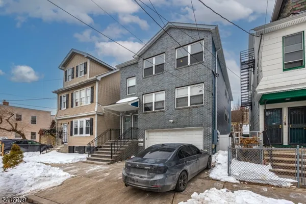 a front view of a residential apartment building with a yard