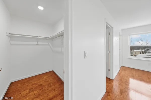 a view of a room with wooden floor and bedroom