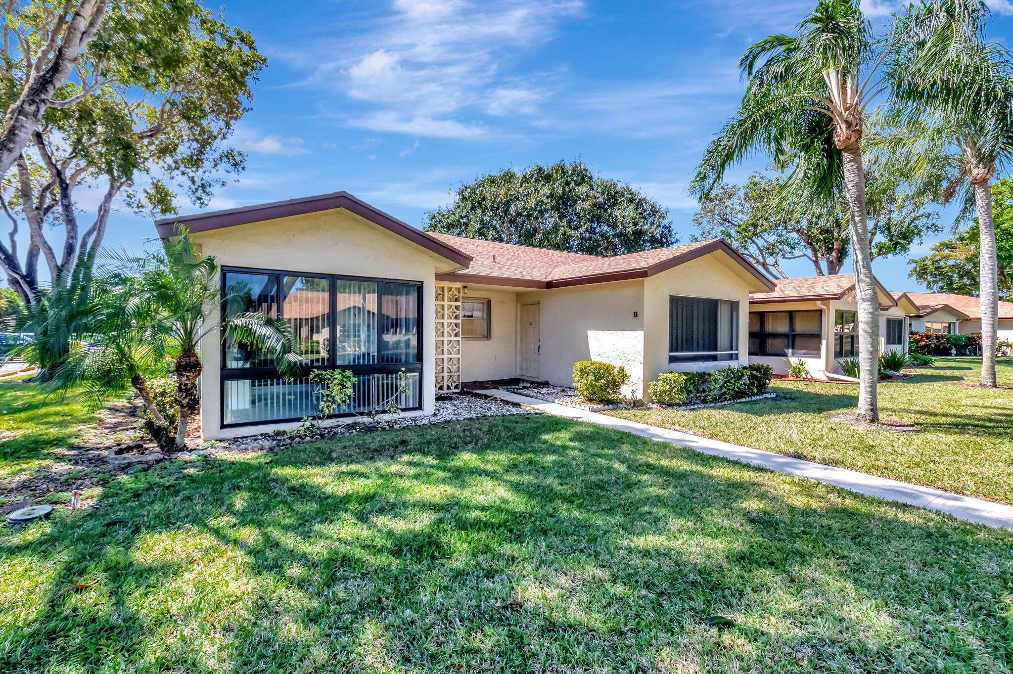 14110 Nesting Way, Unit A Delray Beach, FL 33484 - Photo 1 of 30 a front view of a house with a yard and porch