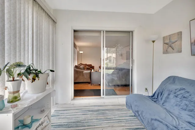 a bedroom with a bed a chandelier and dresser