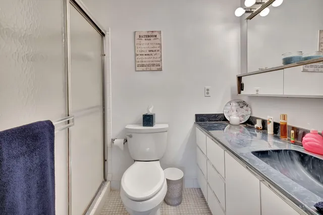a bathroom with a toilet a sink and a mirror