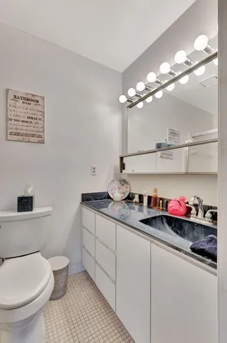 a white toilet sitting next to a bathroom sink