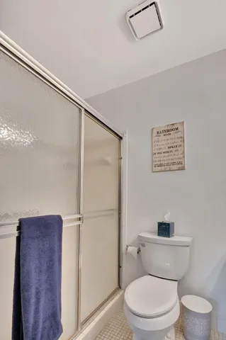 a kitchen with a sink a toilet and cabinets