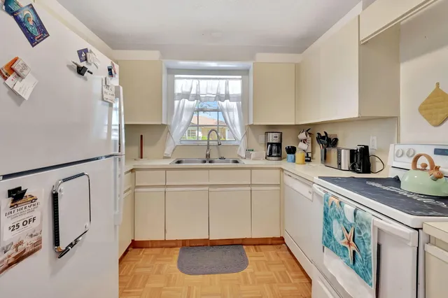 a kitchen with sink cabinets and window