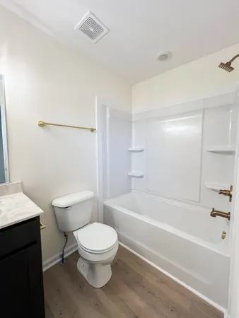 a bathroom with a toilet and a bath tub