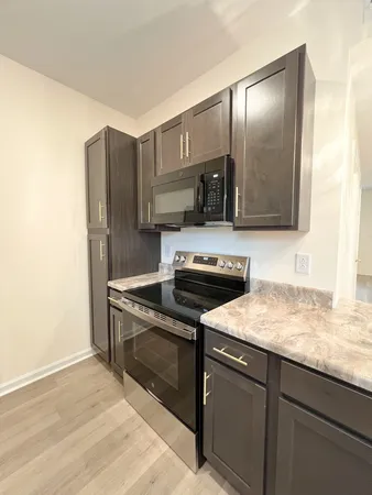 a kitchen with stainless steel appliances granite countertop a sink and a stove