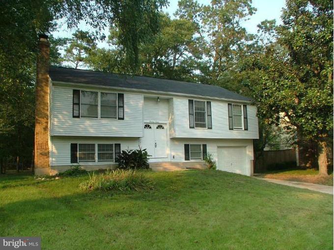 1312 Ava Road Severn, MD 21144 - Photo 1 of 15 a front view of a house with a garden