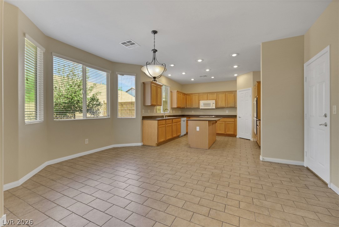10328 Hawk Ravine Street Las Vegas, NV 89178 - Photo 10 of 55 A well-lit kitchen with ample counter space and a convenient center island.