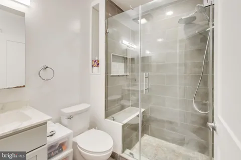a bathroom with a toilet and a shower