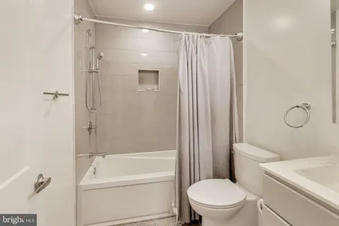 a bathroom with a shower a toilet and a sink