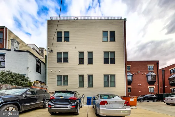 a front view of a house with parking space