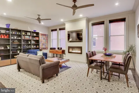 a living room with fireplace furniture and a flat screen tv
