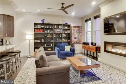 a living room with furniture a rug and a fireplace