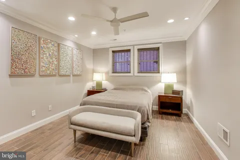 a bedroom with furniture and a wooden floor
