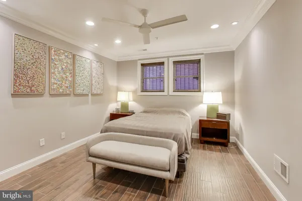 a bedroom with furniture and a wooden floor