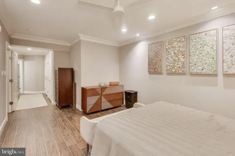 a bedroom with a bed and wooden floor