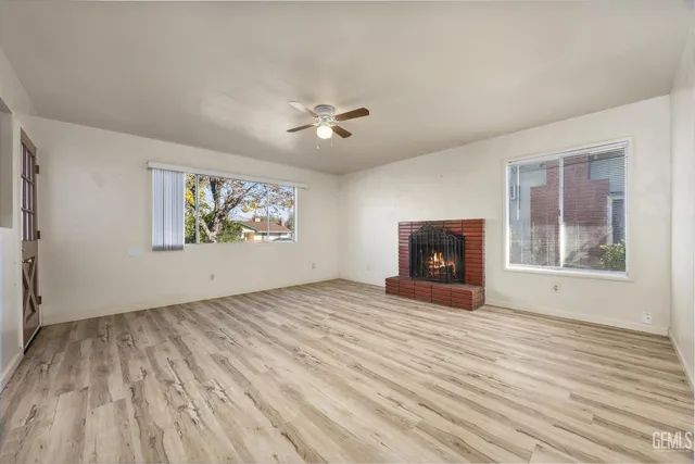 wooden floor in an empty room with a fireplace