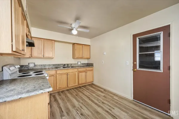 a kitchen with granite countertop cabinets stainless steel appliances a sink and a counter top space