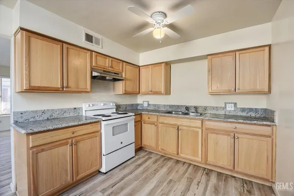 a kitchen with stainless steel appliances granite countertop a sink and cabinets