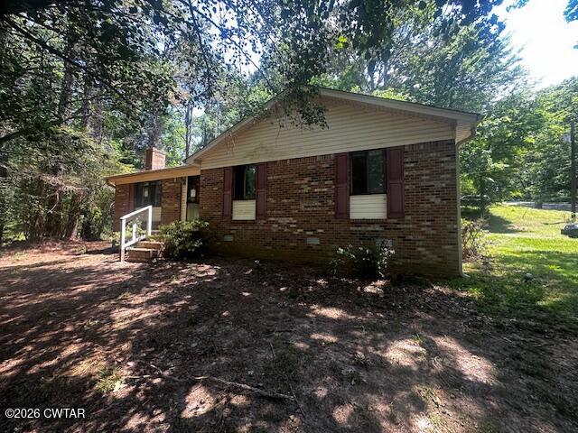 1400 Roper Road Bolivar, TN 38008 - Photo 2 of 23 a front view of house with yard and trees in the background