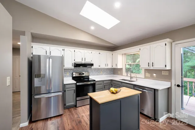 a kitchen with a refrigerator a stove a sink dishwasher and a refrigerator