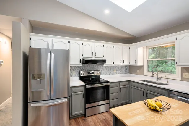 a kitchen with a refrigerator and a stove