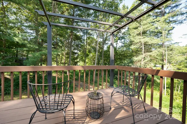 a view of a chair and tables in the balcony