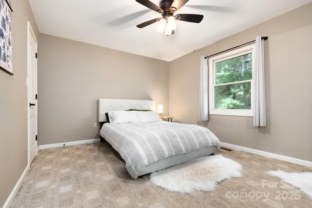 a bedroom with a bed and window