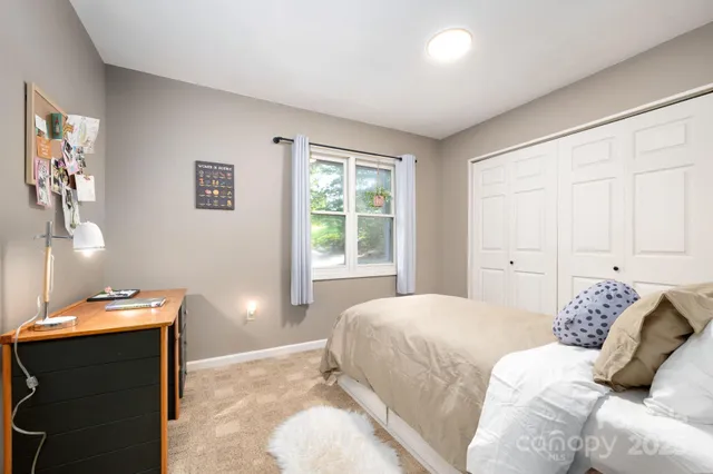 a bedroom with a bed and window