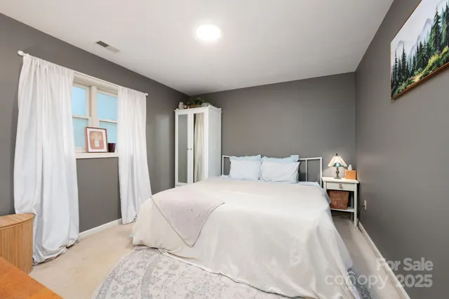 a bedroom with a large bed and a window