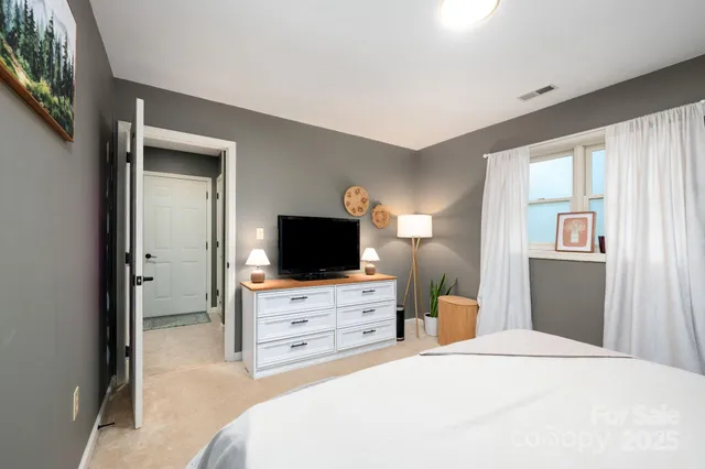 a bedroom with a bed and a flat screen tv in it