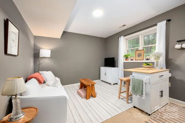 a living room with a sink and a table