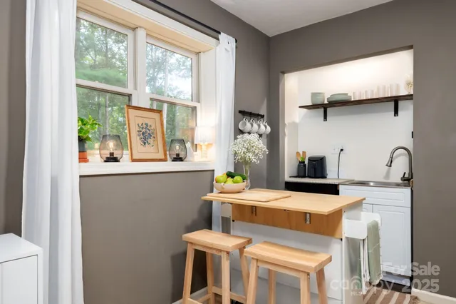 a kitchen that has a stove and a table in it