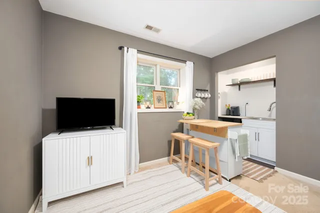 a room with a chair and a flat screen tv