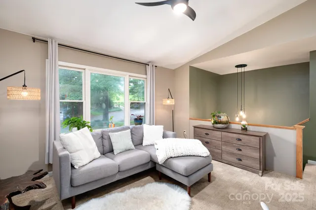 a living room with furniture and a large window
