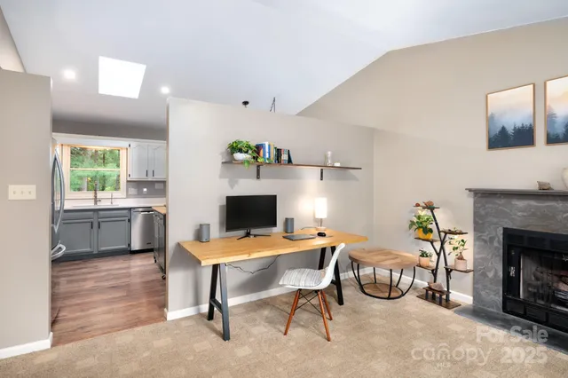 a workspace with furniture and a fireplace