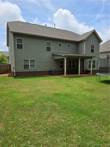 a view of a house with yard and sitting area