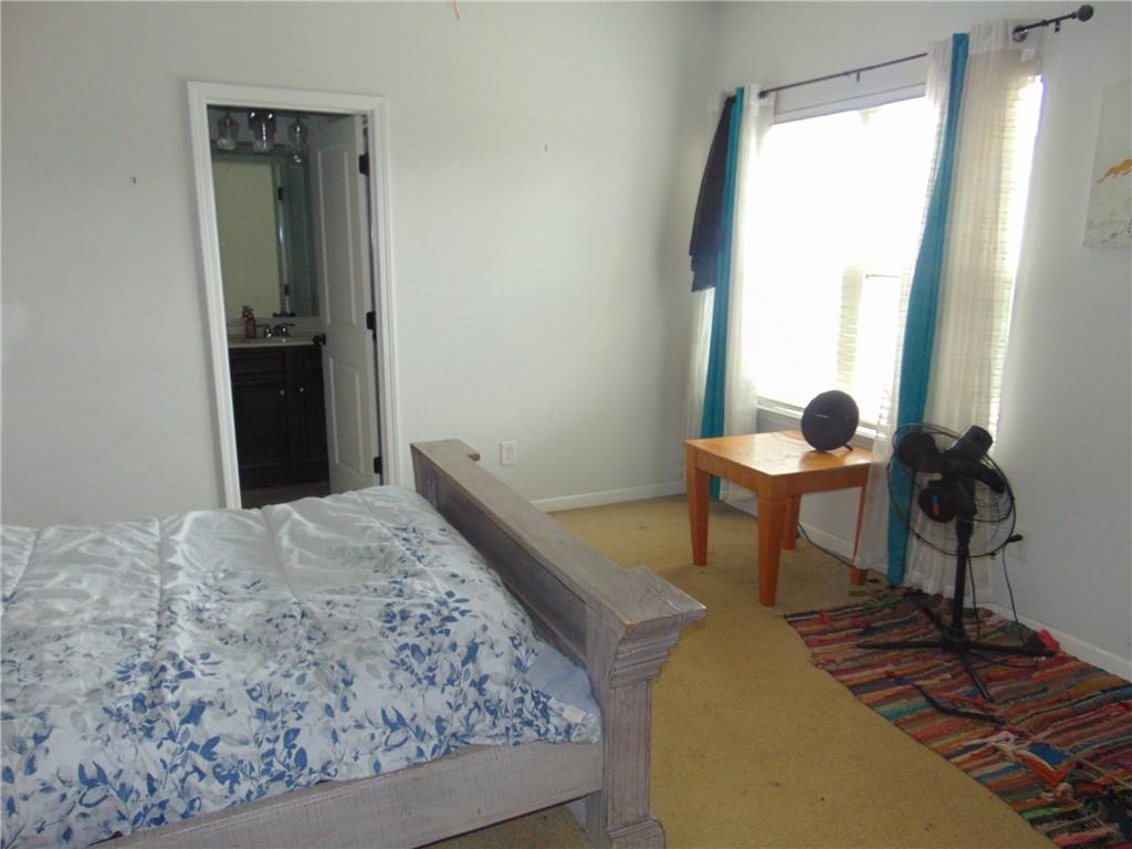 445 Piedmont Circle Covington, GA 30016 - Photo 22 of 24 a bedroom with a bed and a window