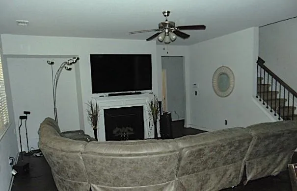 a living room with furniture a flat screen tv and a fireplace