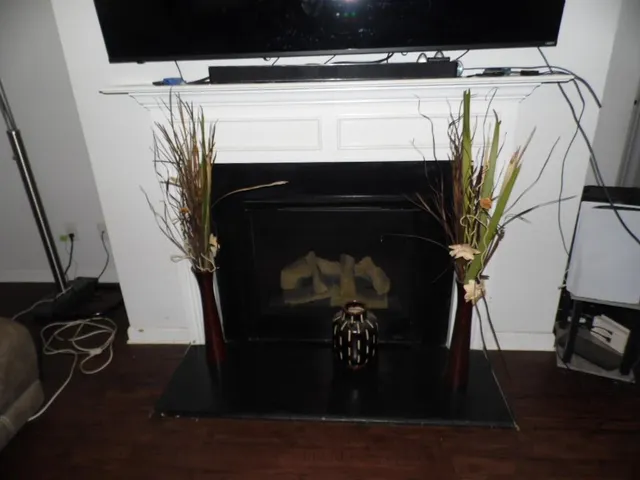 a close view of a fireplace with wooden floor