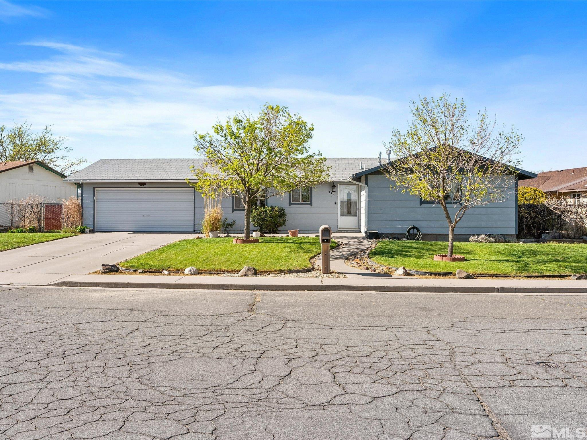 910 Concord Avenue Fallon, NV 89406 - Photo 1 of 40 a view of a house with a yard and garage
