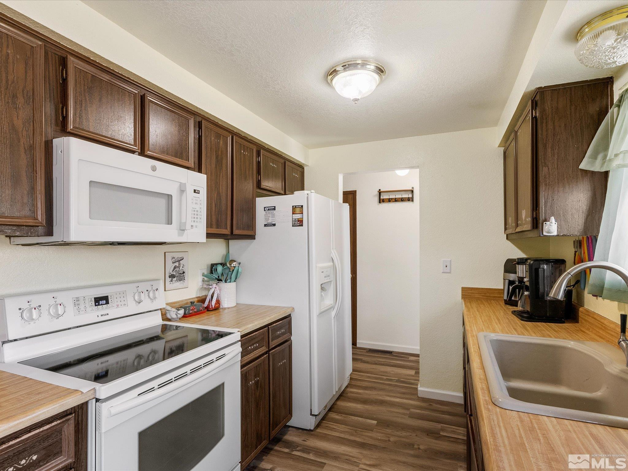 910 Concord Avenue Fallon, NV 89406 - Photo 13 of 40 a kitchen with a refrigerator stove and sink