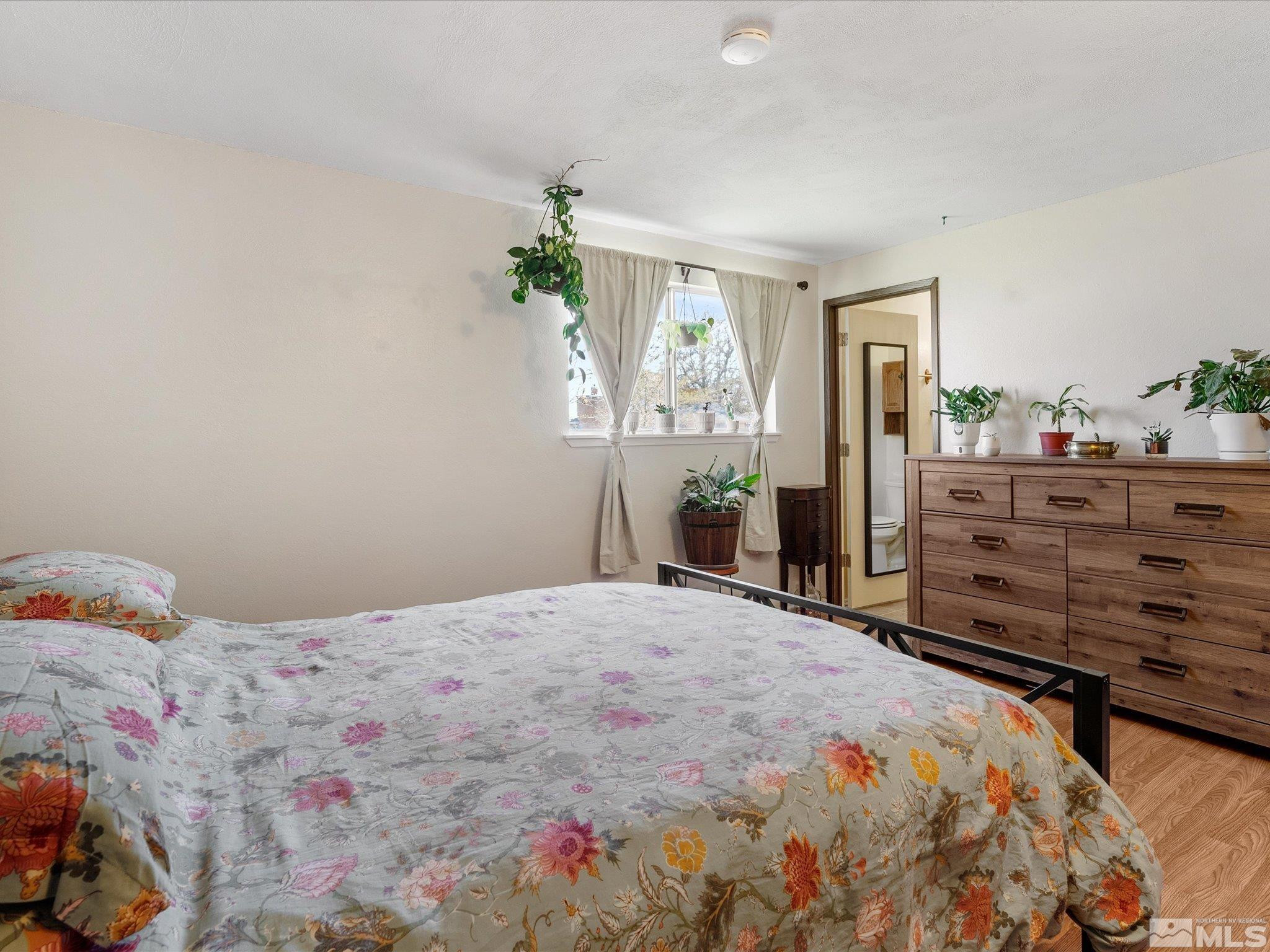 910 Concord Avenue Fallon, NV 89406 - Photo 16 of 40 a bedroom with a bed and wooden floor