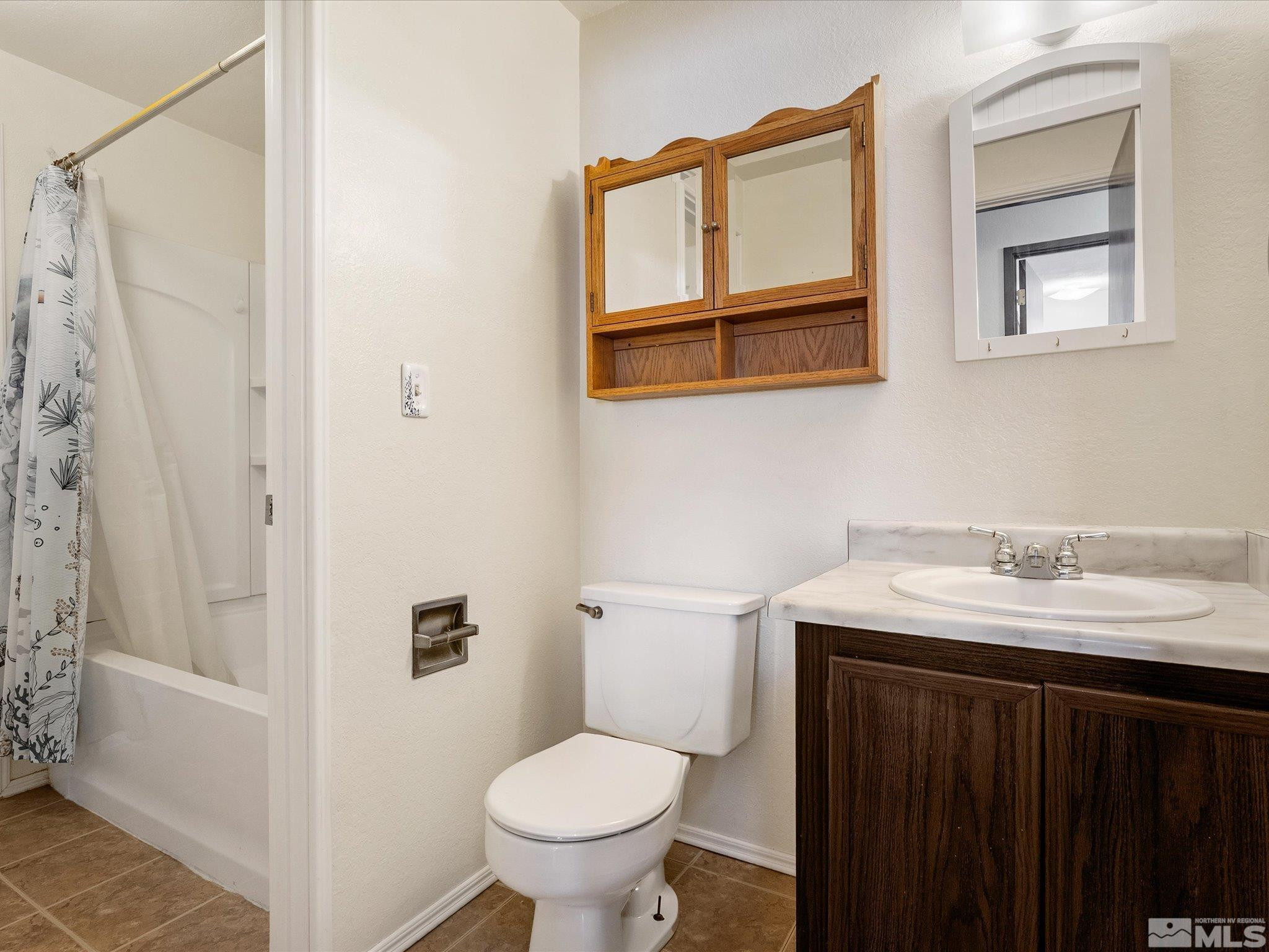 910 Concord Avenue Fallon, NV 89406 - Photo 19 of 40 a bathroom with a granite countertop sink toilet and shower