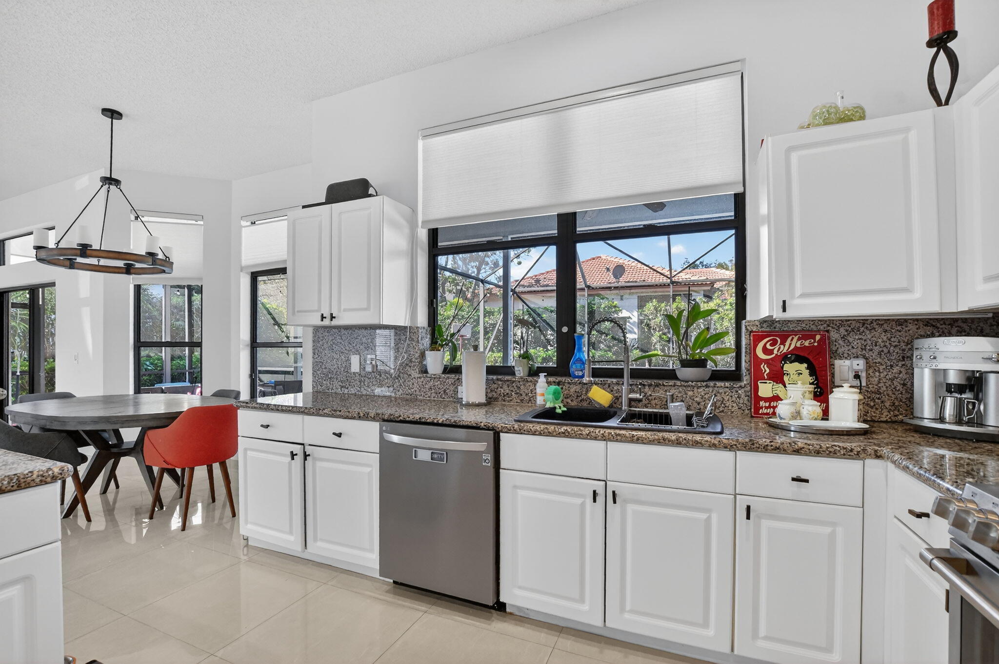 10058 Umberland Place Boca Raton, FL 33428 - Photo 16 of 55 a kitchen with stainless steel appliances a sink and cabinets