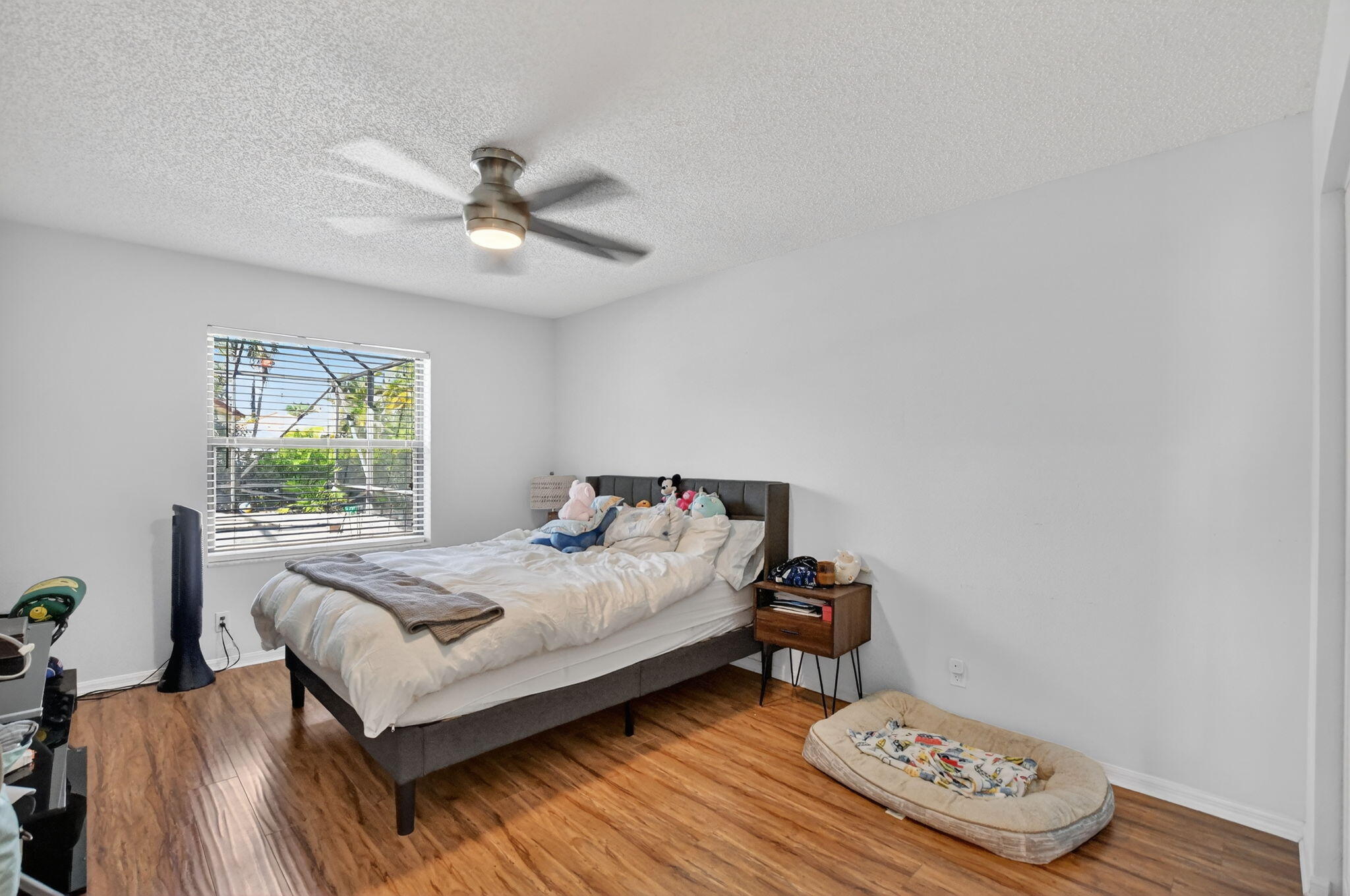 10058 Umberland Place Boca Raton, FL 33428 - Photo 21 of 55 a bedroom with a bed and a chandelier