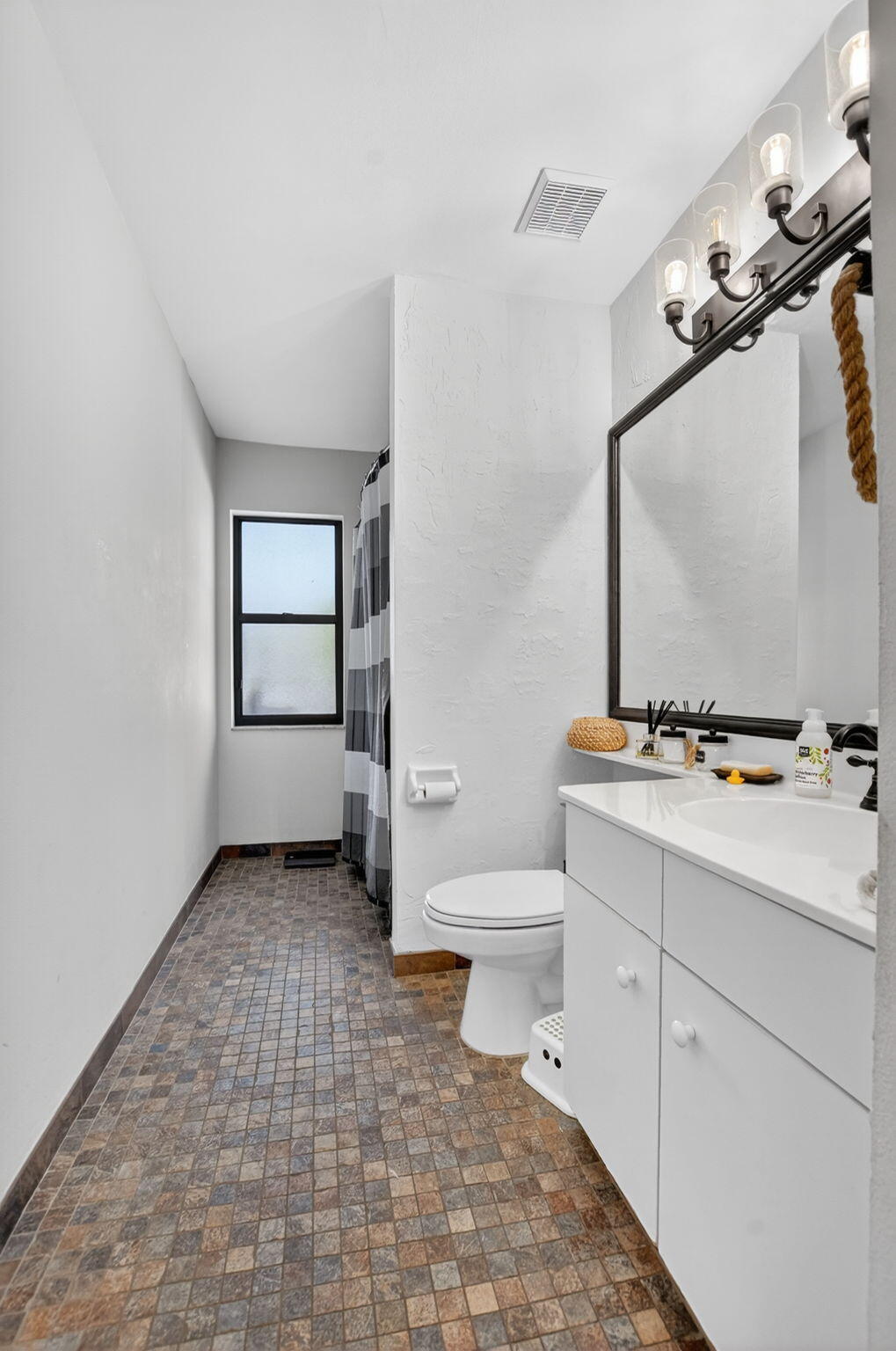 10058 Umberland Place Boca Raton, FL 33428 - Photo 24 of 55 a bathroom with a sink a toilet and mirror